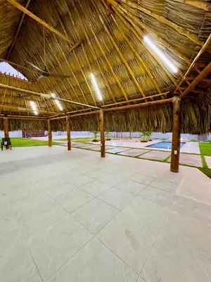 a large straw roofed pavilion with a tile floor at cabaña villa rags in Sabanagrande