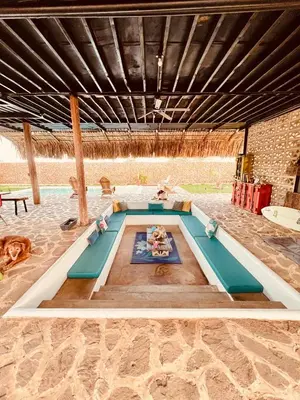 a pool with a table in the middle of a building at KITE en Mojarra Beach Habitación privada vista al mar in Salina de Rey
