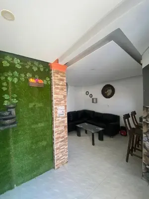 a living room with a couch and a table at Cabaña Tolu Sucre in Santiago
