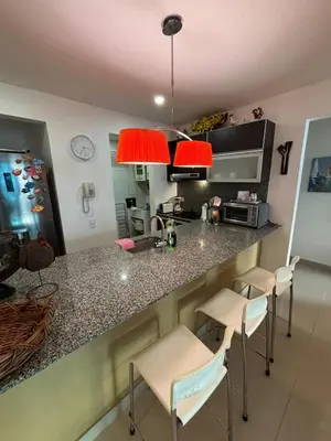 a kitchen with a counter and some stools at Beachfront Luxury Apartment Cartagena in Cartagena de Indias