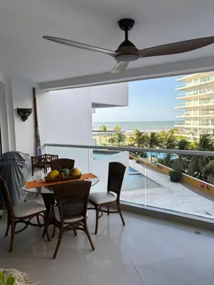 a dining room with a table and a view of the ocean at Beachfront Luxury Apartment Cartagena in Cartagena de Indias