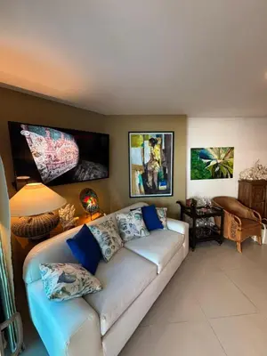 a living room with a white couch with blue pillows at Beachfront Luxury Apartment Cartagena in Cartagena de Indias