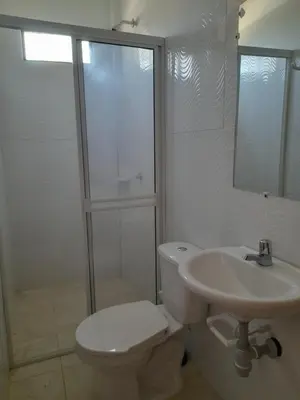 a bathroom with a toilet and a sink and a shower at Cabaña frente al mar de San Antero in San Antero