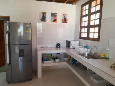 a kitchen with a stainless steel refrigerator and a sink at Cabaña frente al mar de San Antero in San Antero