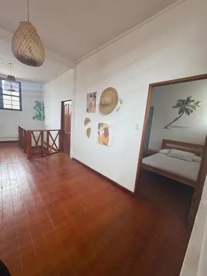 a room with a bedroom with a bed and a mirror at Cabaña frente al mar de San Antero in San Antero