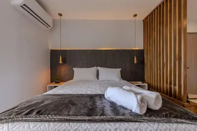 a bedroom with a bed with white sheets and pillows at Unbeatable Location -Exclusive Views- Clock Tower in Cartagena de Indias
