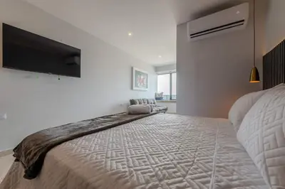 a bedroom with a large bed and a flat screen tv at Unbeatable Location -Exclusive Views- Clock Tower in Cartagena de Indias
