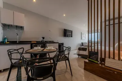 a kitchen and living room with a table and chairs at Unbeatable Location -Exclusive Views- Clock Tower in Cartagena de Indias
