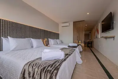 a hotel room with two beds and a flat screen tv at Spectacular City Views -Prime Location-Clock Towe in Cartagena de Indias