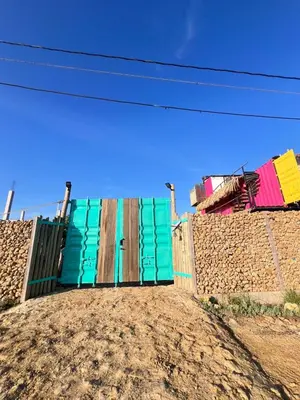 a colorful gate on top of a dirt hill at Love en Mojarra Beach Habitación privada vista al mar in Salina de Rey