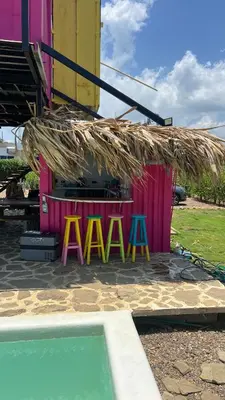 a building with a sign that says maan next to a pool at Love en Mojarra Beach Habitación privada vista al mar in Salina de Rey