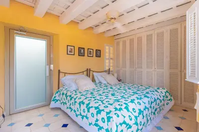 a bedroom with a bed in a room with yellow walls at Casa azul in Cartagena de Indias