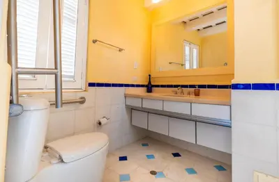 a bathroom with a toilet and a sink and a mirror at Casa azul in Cartagena de Indias