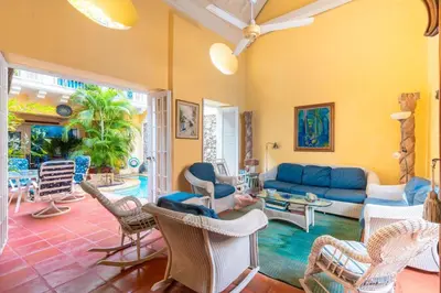 a living room with a blue couch and chairs at Casa azul in Cartagena de Indias