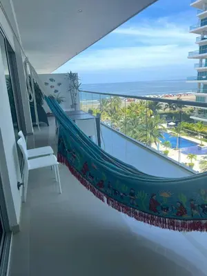 a hammock on a balcony with a view of the ocean at Hermoso apartamento MORROS EPIC in Cartagena de Indias
