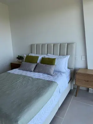 a bedroom with a large bed and a wooden table at Baia Kristal 5I in Estación El Salto