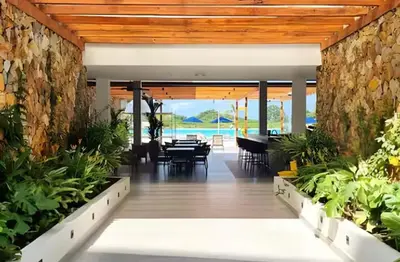 a dining room with a table and some plants at Baia Kristal 5I in Estación El Salto