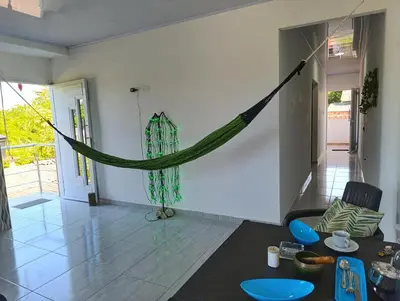 a living room with a hammock hanging from the wall at Apartamento cerca a la playa in El Porvenir