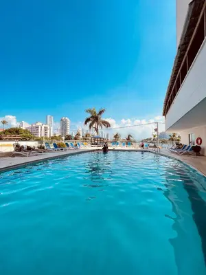 a large swimming pool with a city in the background at Loft Vista al Laguito in Cartagena de Indias