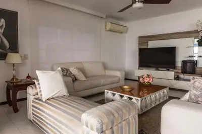 a living room with a couch and a tv at Apartamento frente al mar in Cartagena de Indias
