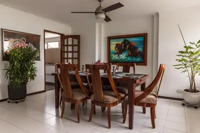 a dining room with a wooden table and chairs at Apartamento frente al mar in Cartagena de Indias