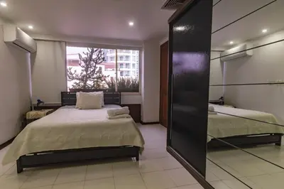 a bedroom with two beds and a mirror at Apartamento frente al mar in Cartagena de Indias