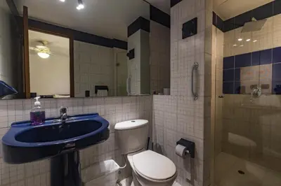 a bathroom with a toilet and a sink and a shower at Apartamento frente al mar in Cartagena de Indias