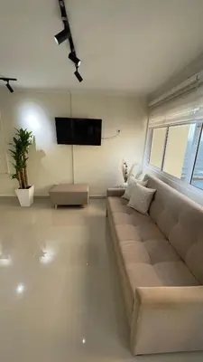 a living room with a couch and a flat screen tv at Cabrero Beach 1213 in Cartagena de Indias
