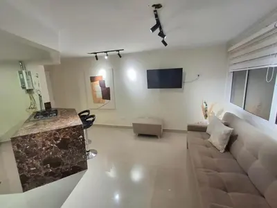 a living room with a couch and a flat screen tv at Cabrero Beach 1213 in Cartagena de Indias