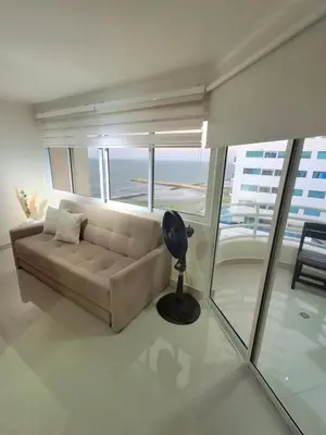 a living room with a couch and a large window at Cabrero Beach 1213 in Cartagena de Indias