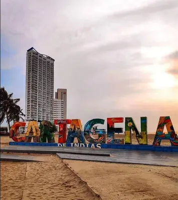 a sign on the beach in front of a city at Cabrero Beach 1213 in Cartagena de Indias