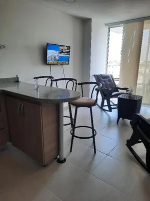 a living room with a table and chairs and a tv at Apartamento completo in Cartagena de Indias