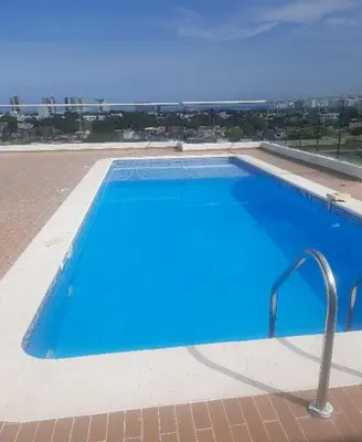 a large blue swimming pool on top of a building at Apartamento completo in Cartagena de Indias