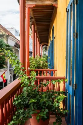a balcony with potted plants on a building at Casa Trujillo in Cartagena de Indias