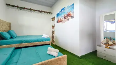 a bedroom with two bunk beds and a window at Hostal barú in Bolivar
