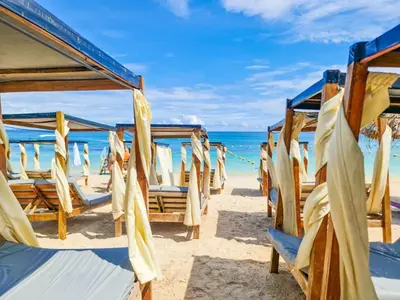 a row of chairs on the beach at Hostal barú in Bolivar