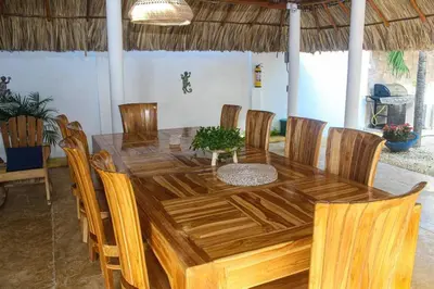 a wooden dining table and chairs in a room at Chalet Ledymar in Cartagena de Indias