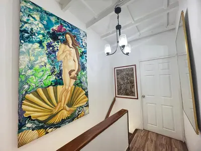 a large painting of a woman on a wall in a hallway at Hermoso duplex en la ciudad amurallada! A218 in Cartagena de Indias