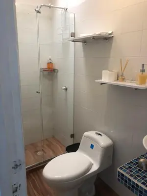 a bathroom with a toilet and a glass shower at Hermoso duplex en la ciudad amurallada! A218 in Cartagena de Indias