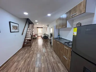 a kitchen with a refrigerator and a staircase in it at Hermoso duplex en la ciudad amurallada! A218 in Cartagena de Indias