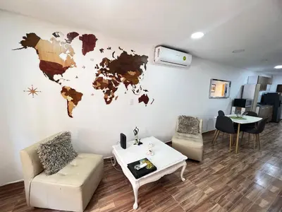 a living room with a map of the world on the wall at Hermoso duplex en la ciudad amurallada! A218 in Cartagena de Indias