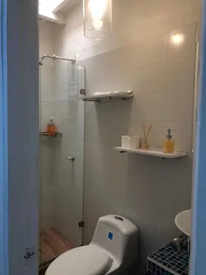 a bathroom with a toilet and a glass shower at Hermoso duplex en la ciudad amurallada! A218 in Cartagena de Indias