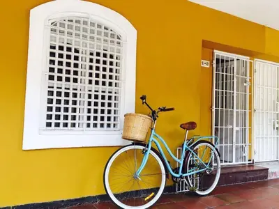 a blue bike parked next to a yellow wall at Hermoso apto estudio en la ciudad amurallada! in Cartagena de Indias