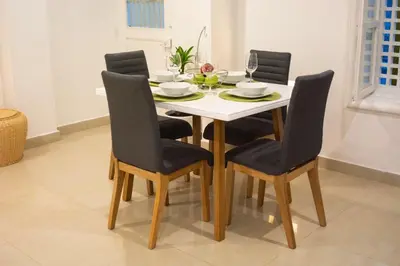 a dining room table with four chairs and a white table at Hermoso apto estudio en la ciudad amurallada! in Cartagena de Indias