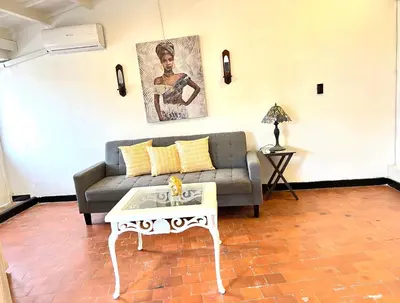 a living room with a couch and a coffee table at Lovely Duplex with balcony! in Cartagena de Indias