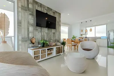 a living room with a tv on a wall at Beachfront Penthouse 40th Sea View/Historic Center in Cartagena de Indias