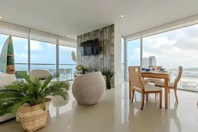 a living room with a table and a dining room at Beachfront Penthouse 40th Sea View/Historic Center in Cartagena de Indias