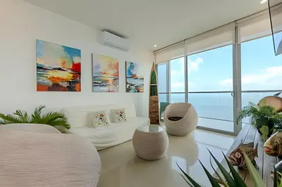 a living room with white furniture and large windows at Beachfront Penthouse 40th Sea View/Historic Center in Cartagena de Indias