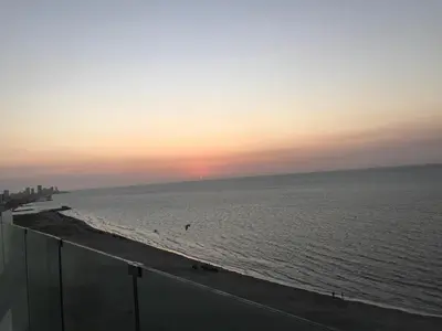 a view of the ocean at sunset with a beach at Apartamento con vista directa al mar en Spiaggia di Cartagena in Cartagena de Indias
