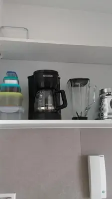 a shelf with a coffee pot and a blender at Apartamento con vista directa al mar en Spiaggia di Cartagena in Cartagena de Indias